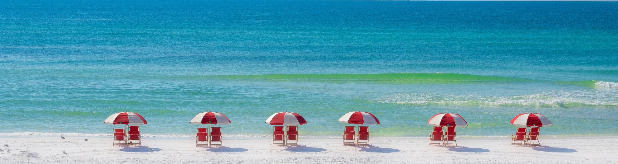 Colorful Row of Red Chairs on the Beach